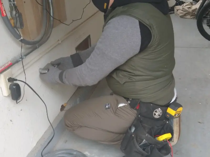 Electrician performing outlet wiring in a North Strabane garage